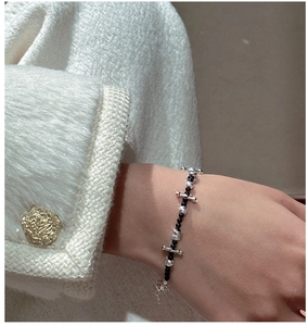 Close-up of S925 sterling silver beaded bracelet with black beads on a model wrist