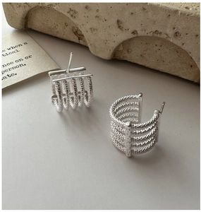 Close-up of S925 sterling silver earrings with five-layer textured metallic design