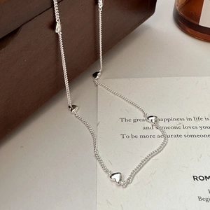 Minimalist S925 sterling silver necklace with polished heart charms on a delicate chain