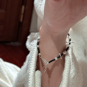 Minimalist S925 sterling silver beaded bracelet with cross charms on a female wrist