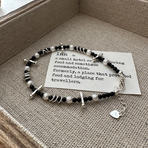 Elegant S925 sterling silver beaded bracelet with black onyx and heart tag on wooden tray