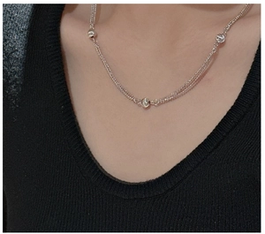 Macro shot of silver layered necklace with three polished beads on S925 silver chain