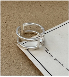Macro view of S925 sterling silver double-layered open ring with hammered texture and stone