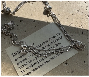 Detail of S925 sterling silver triple layer bead necklace with brushed metallic beads