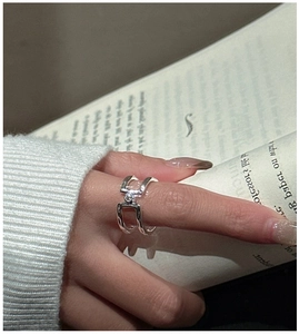 Close-up of S925 sterling silver double-layered open ring with a clear zircon stone