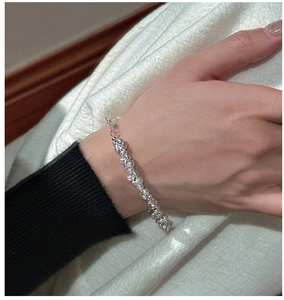 Close-up of S925 sterling silver beaded bracelet with sparkling facets on a model's wrist