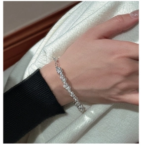 Macro detail of S925 sterling silver beaded bracelet with adjustable chain on wrist
