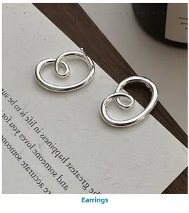 Macro shot of S925 sterling silver earrings with abstract layered swirl design