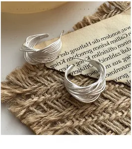 Detail view of S925 sterling silver multilayer C-shaped earrings with brushed texture
