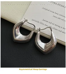 Detailed view of polished S925 silver irregular U-shaped hoop earrings on black leather