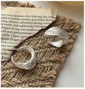 Detail of woven S925 sterling silver hoop earrings with vintage frosted finish