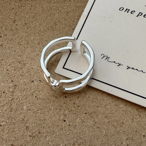 Double-layered S925 sterling silver open ring with a small round zircon on rustic wood