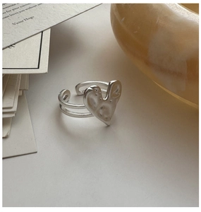 Close-up of S925 sterling silver heart ring with hammered texture and open band design