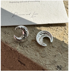 Detailed view of S925 sterling silver crescent earrings with hammered vintage texture
