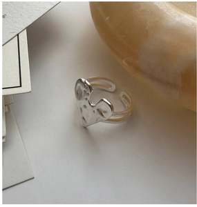Detailed view of hammered texture on silver heart ring with adjustable double layer band