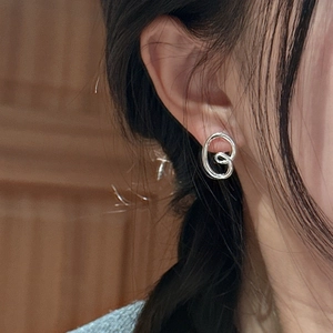 S925 sterling silver spiral earrings with minimalist abstract lines on a female model