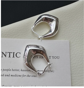 Detailed view of S925 sterling silver geometric huggie earrings with S925 hallmark stamp