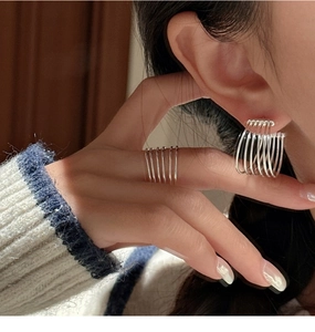 Detail of minimalist S925 sterling silver multilayer line ring and matching earrings set