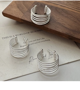 Detail shot of multilayer S925 sterling silver hoop earrings with a sleek minimalist design