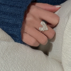 Minimalist S925 sterling silver heart ring with textured finish worn on index finger