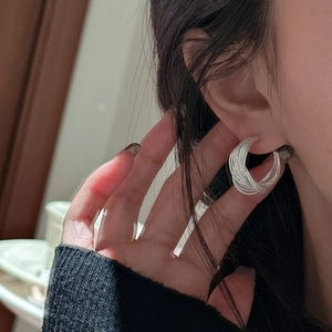 Minimalist S925 sterling silver multi-layer intertwined hoop earrings on model