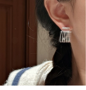 Close-up of S925 sterling silver multilayer hoop earrings worn on ear for minimalist style