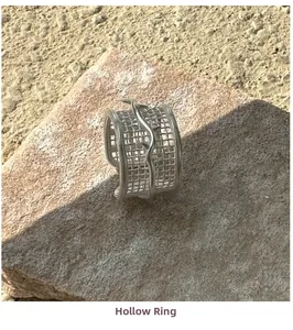 Detailed close-up of S925 silver mesh ring with textured wave line on beige stone