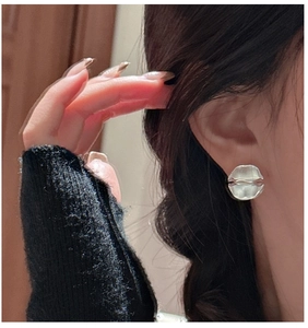 Detailed close-up of S925 sterling silver earrings with irregular matte wrinkled texture