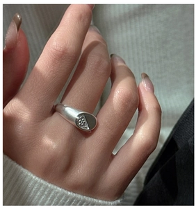 Macro detail of S925 sterling silver ring featuring a beaded matte texture and sleek cut