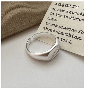 Macro shot of S925 sterling silver matte ring with pavé cubic zirconia inlay and open band