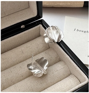 Detailed macro view of S925 sterling silver matte wrinkled petal stud earrings