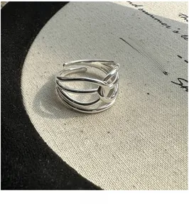 Close-up of a minimalist S925 sterling silver multi-layered crisscross open ring design
