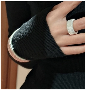 Close-up of S925 silver rings and bracelet featuring fine threaded horizontal texture