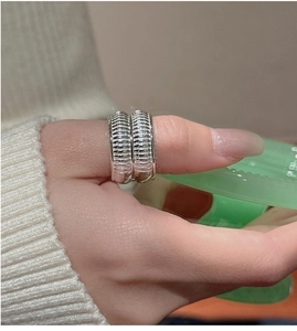 Close-up of wide S925 silver ribbed ring with vintage textured finish on thumb