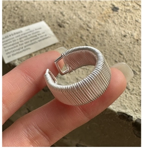 Detailed macro shot of S925 sterling silver ring with unique spiral textured wire design