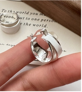 Detail view of S925 sterling silver hoop earrings with white enamel drip glaze finish