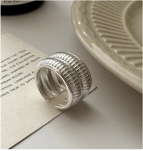Detailed view of wide textured S925 sterling silver ring with horizontal ridges