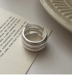Macro detail of adjustable S925 sterling silver ring with textured vertical fluted design