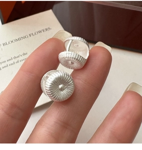Close-up of S925 sterling silver hoop earrings with organic radial texture detail