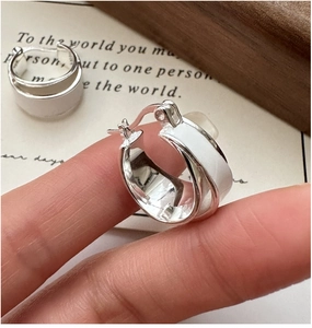 Close-up of S925 sterling silver hoop earring with white enamel and hallmark stamp