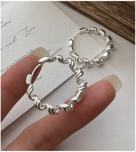 Close-up of S925 sterling silver twisted hoop earring showing the authentic hallmark