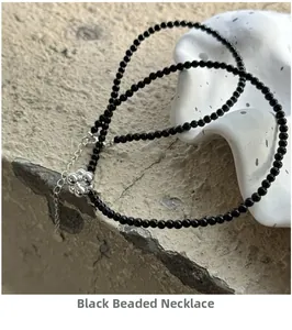 Close-up of S925 silver beaded necklace with black onyx beads and flower cluster pendant