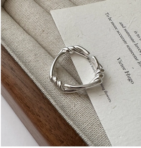 Close-up of S925 sterling silver twisted knot ring with adjustable open design band
