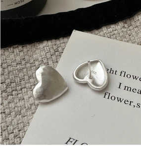 Detail of matte silver S925 sterling silver heart stud earrings with S925 hallmark stamp