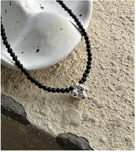 Detailed view of S925 silver beaded necklace featuring a unique black onyx sphere pendant