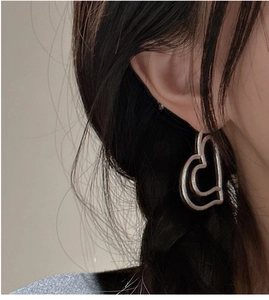 Detailed side view of vintage S925 sterling silver matte double heart drop earrings