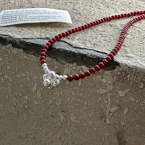 Retro S925 silver beaded necklace with red stones and floral cluster pendant on stone