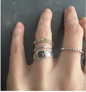 Detail of S925 sterling silver retro rings with red gemstone and wave patterns