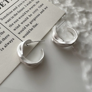Minimalist S925 sterling silver C-shaped twisted earrings with a matte textured finish