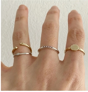 Stackable S925 sterling silver minimalist rings with stone accents on a hand